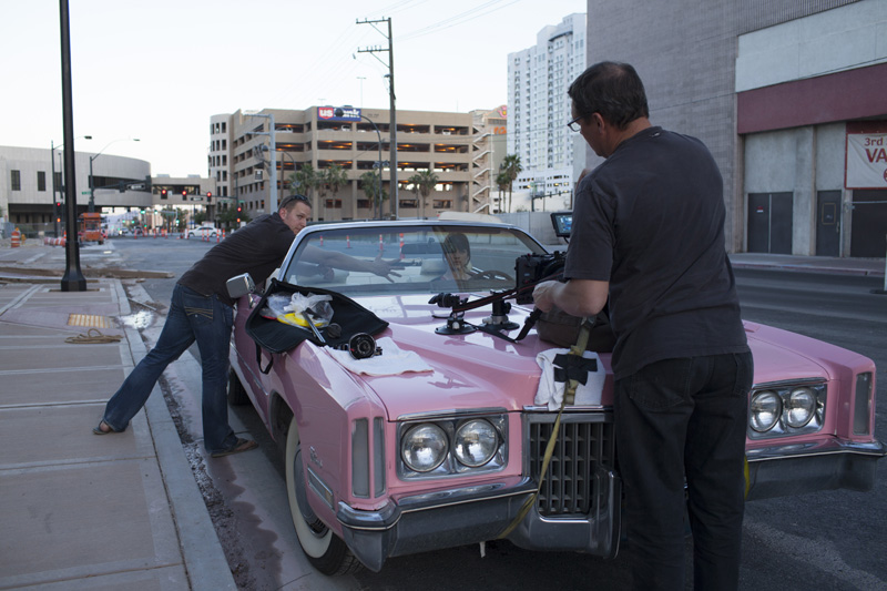 setting up camera equipment on a car